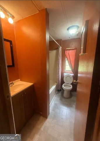 a bathroom with a toilet and a sink