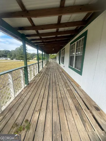 a view of outdoor space with wooden floor