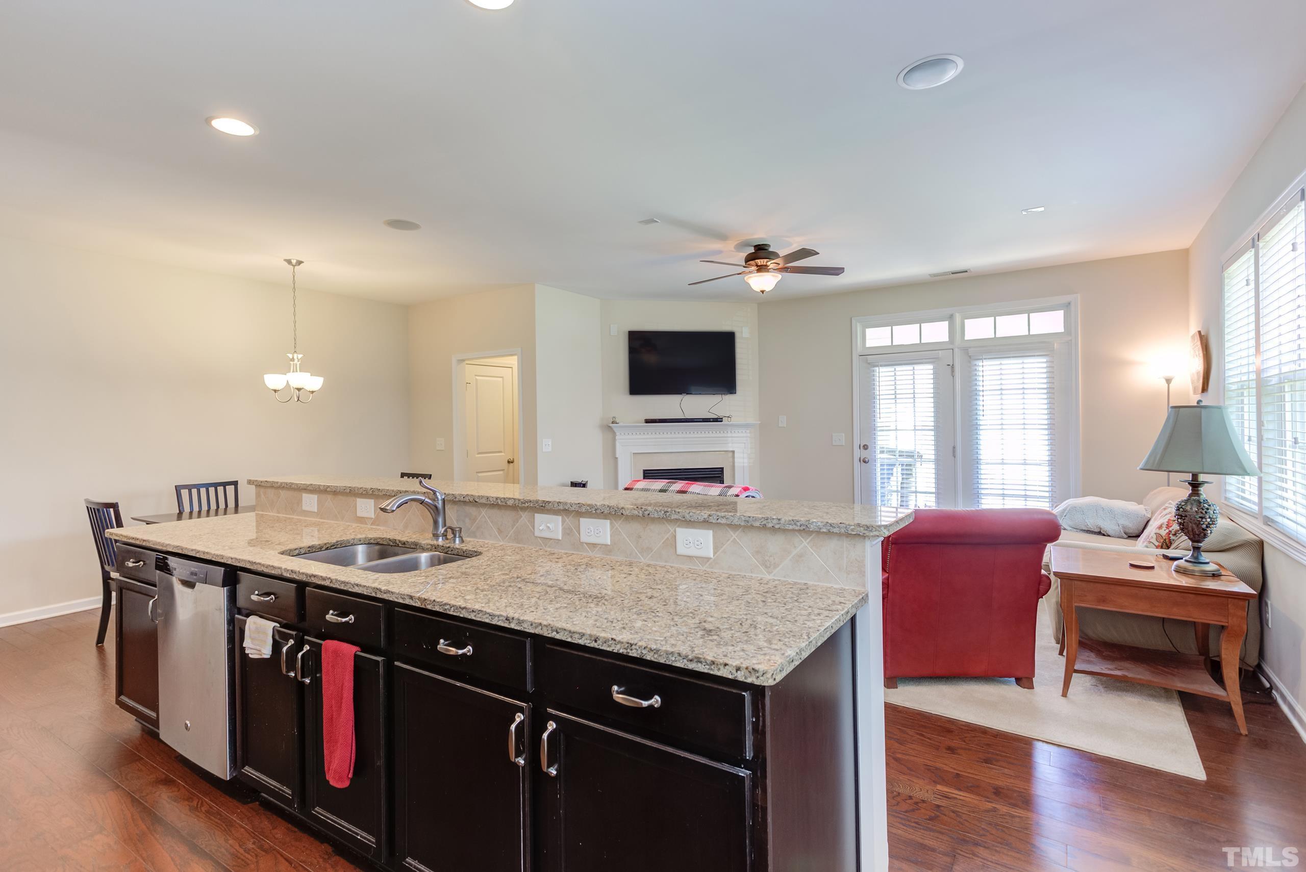 1313 Still Monument Way Raleigh, NC 27603 - Photo 11 of 35 a kitchen with stainless steel appliances granite countertop a sink and a granite counter tops