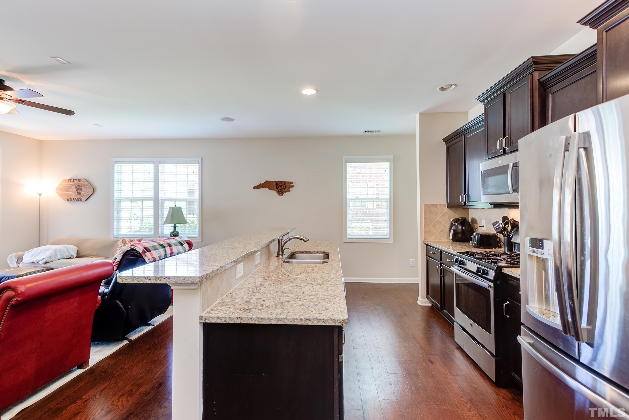1313 Still Monument Way Raleigh, NC 27603 - Photo 12 of 35 a kitchen with refrigerator a stove and a sink