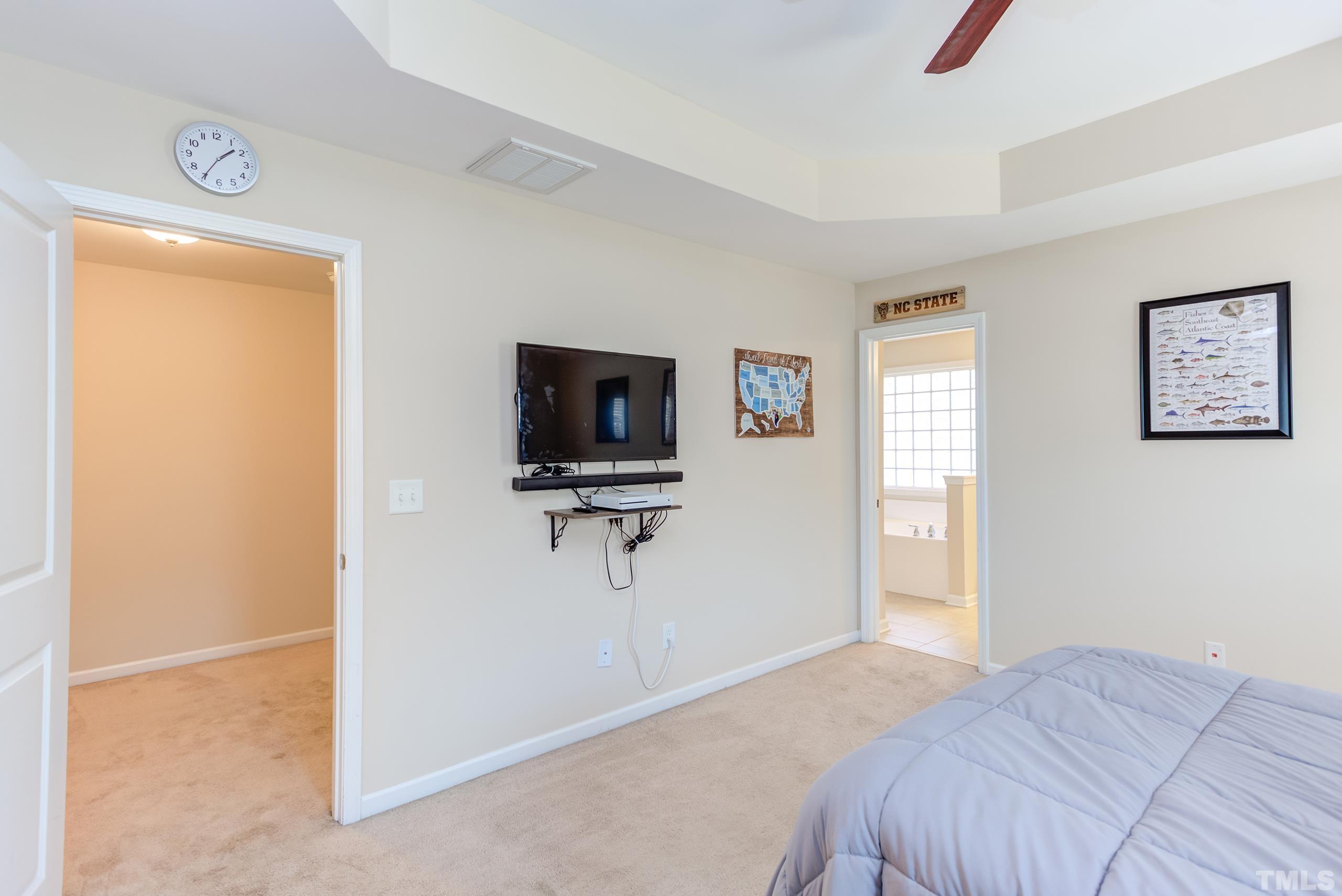 1313 Still Monument Way Raleigh, NC 27603 - Photo 18 of 35 a bedroom with a bed and a flat screen tv