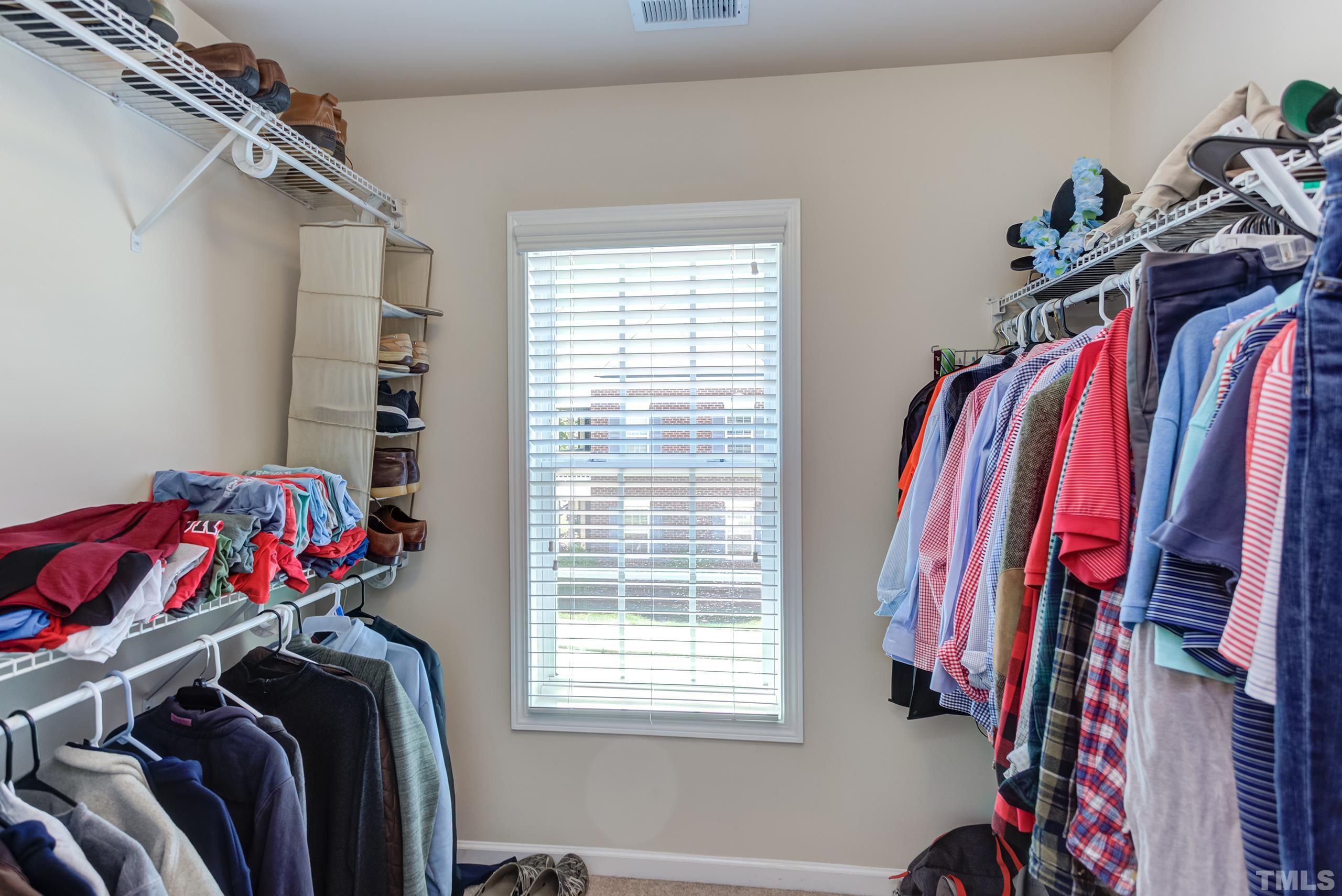 1313 Still Monument Way Raleigh, NC 27603 - Photo 21 of 35 a view of walk in closet with clothes and shoes