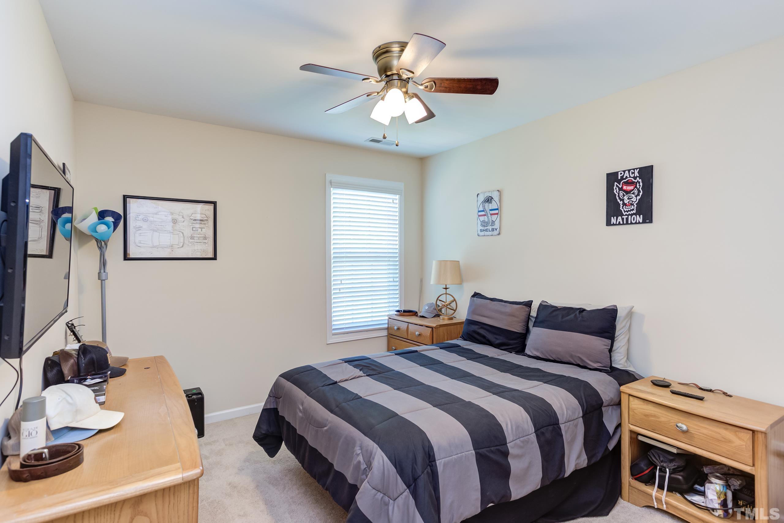 1313 Still Monument Way Raleigh, NC 27603 - Photo 22 of 35 a bedroom with bed and a chandelier