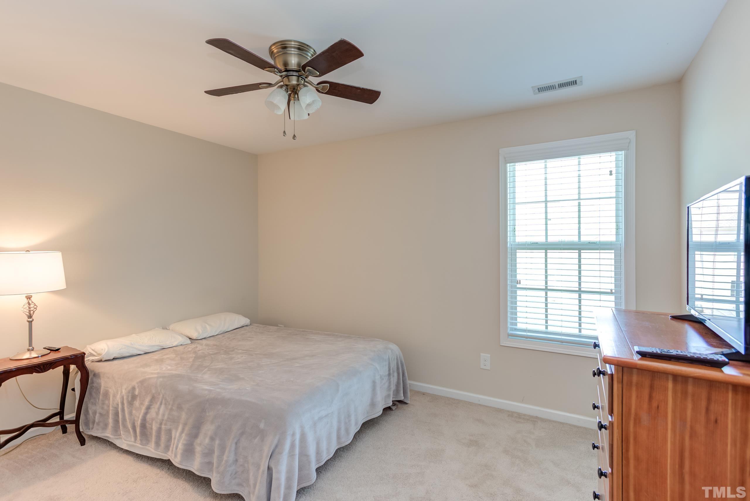 1313 Still Monument Way Raleigh, NC 27603 - Photo 23 of 35 a bedroom with a bed and window