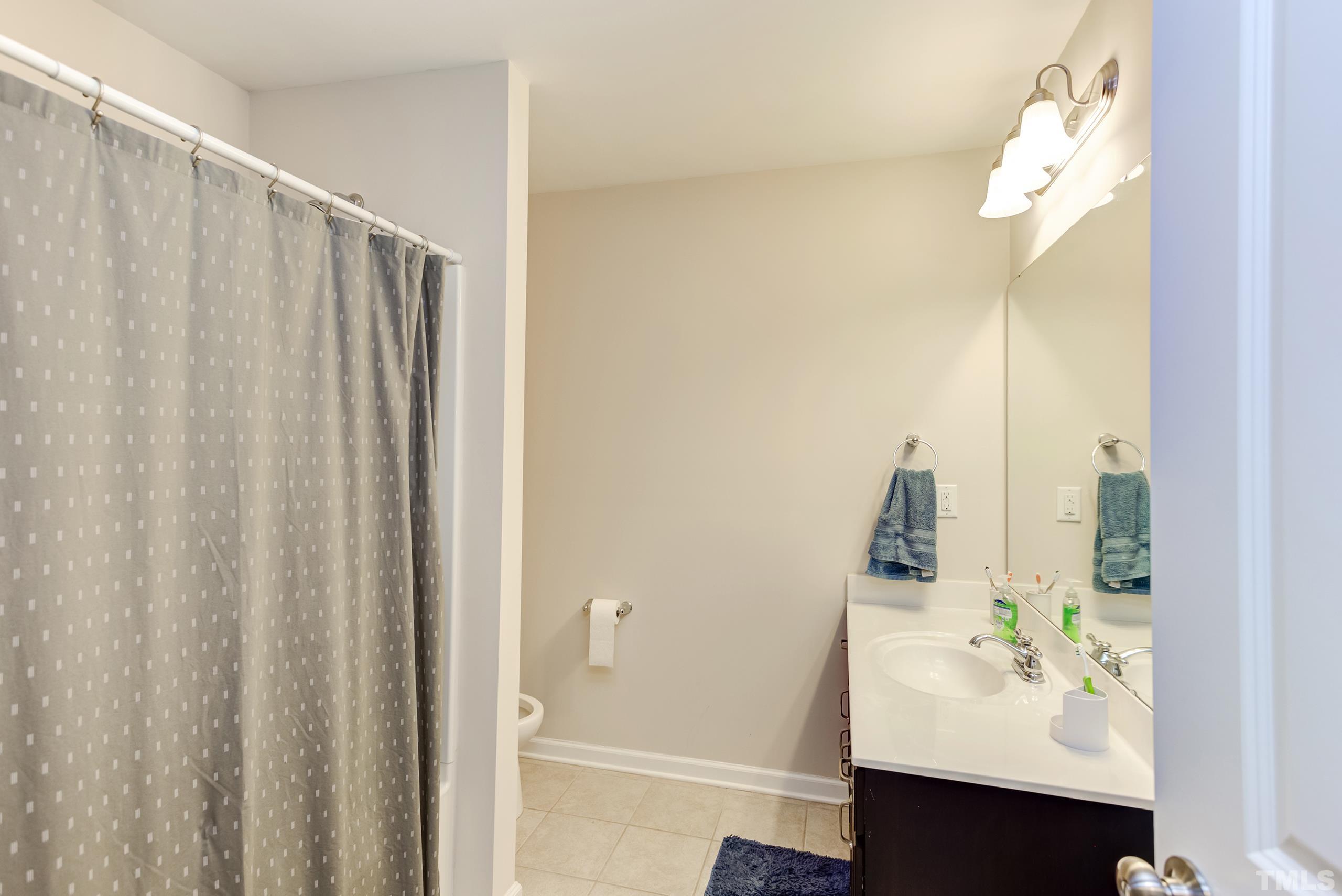 1313 Still Monument Way Raleigh, NC 27603 - Photo 24 of 35 a bathroom with a sink and a mirror