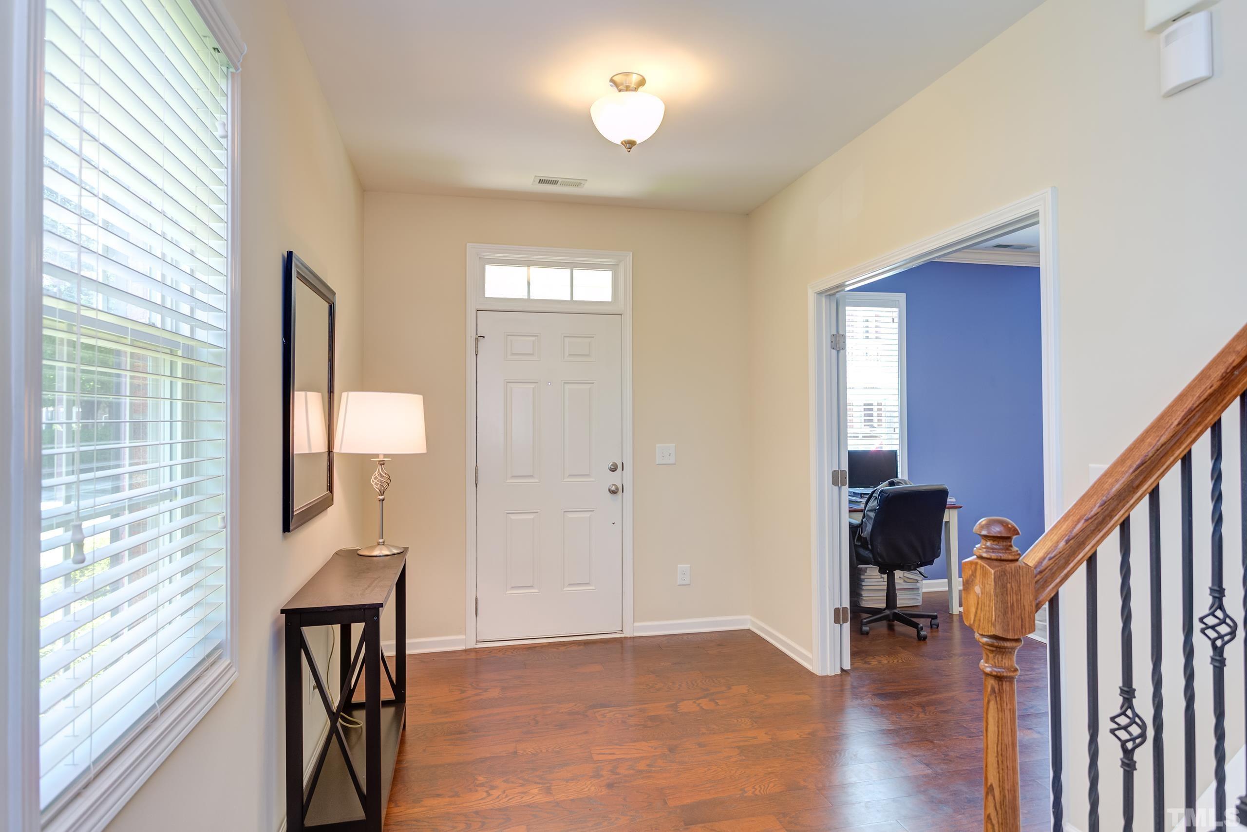 1313 Still Monument Way Raleigh, NC 27603 - Photo 3 of 35 a view of a livingroom with wooden floor and furniture