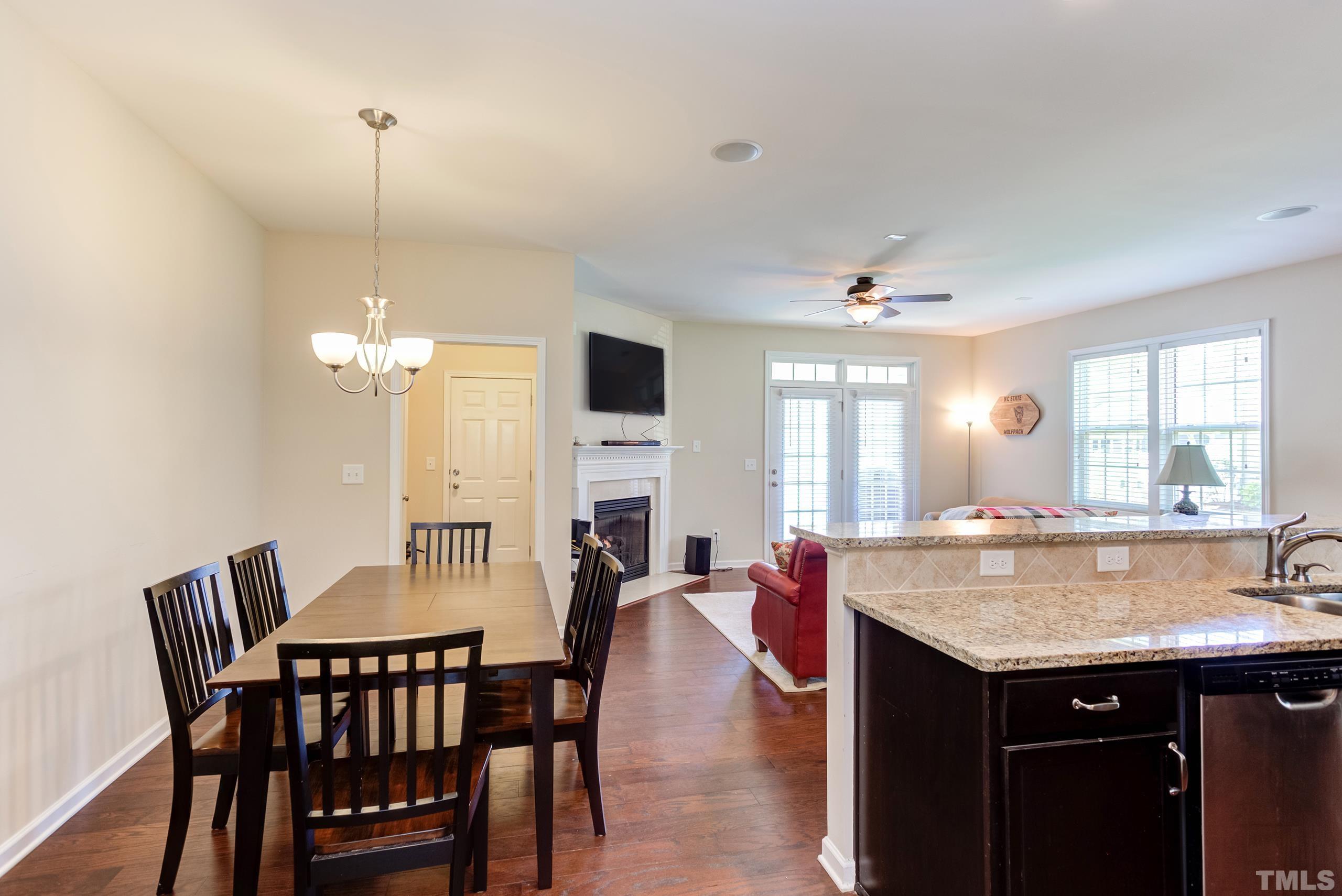 1313 Still Monument Way Raleigh, NC 27603 - Photo 7 of 35 a dining table with chairs and chandelier