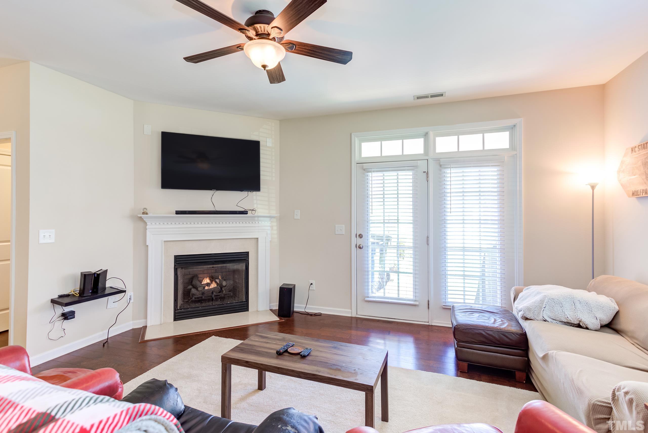 1313 Still Monument Way Raleigh, NC 27603 - Photo 10 of 35 a living room with furniture a flat screen tv and a fireplace