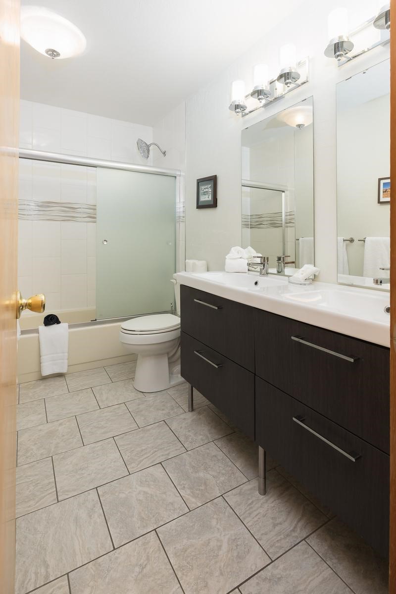 91100 Ryan Gulch Road, Unit 91105 Silverthorne, CO 80498 - Photo 17 of 49 a bathroom with a sink a toilet and mirror