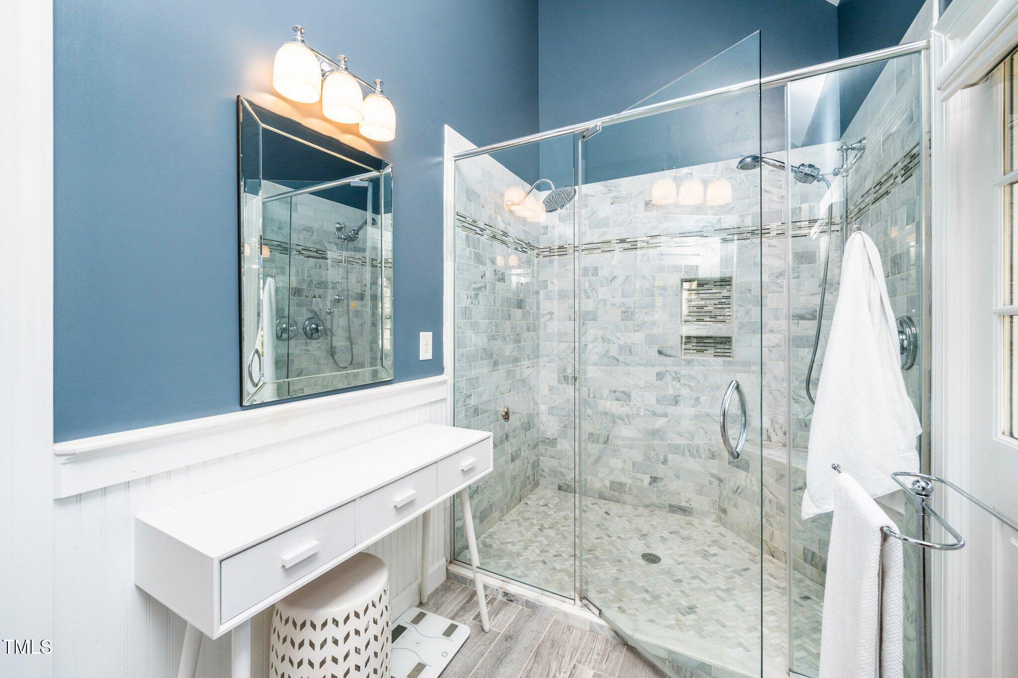 1712 Briarforest Place Raleigh, NC 27615 - Photo 21 of 55 Frameless tiled walk-in shower in the primary bathroom.