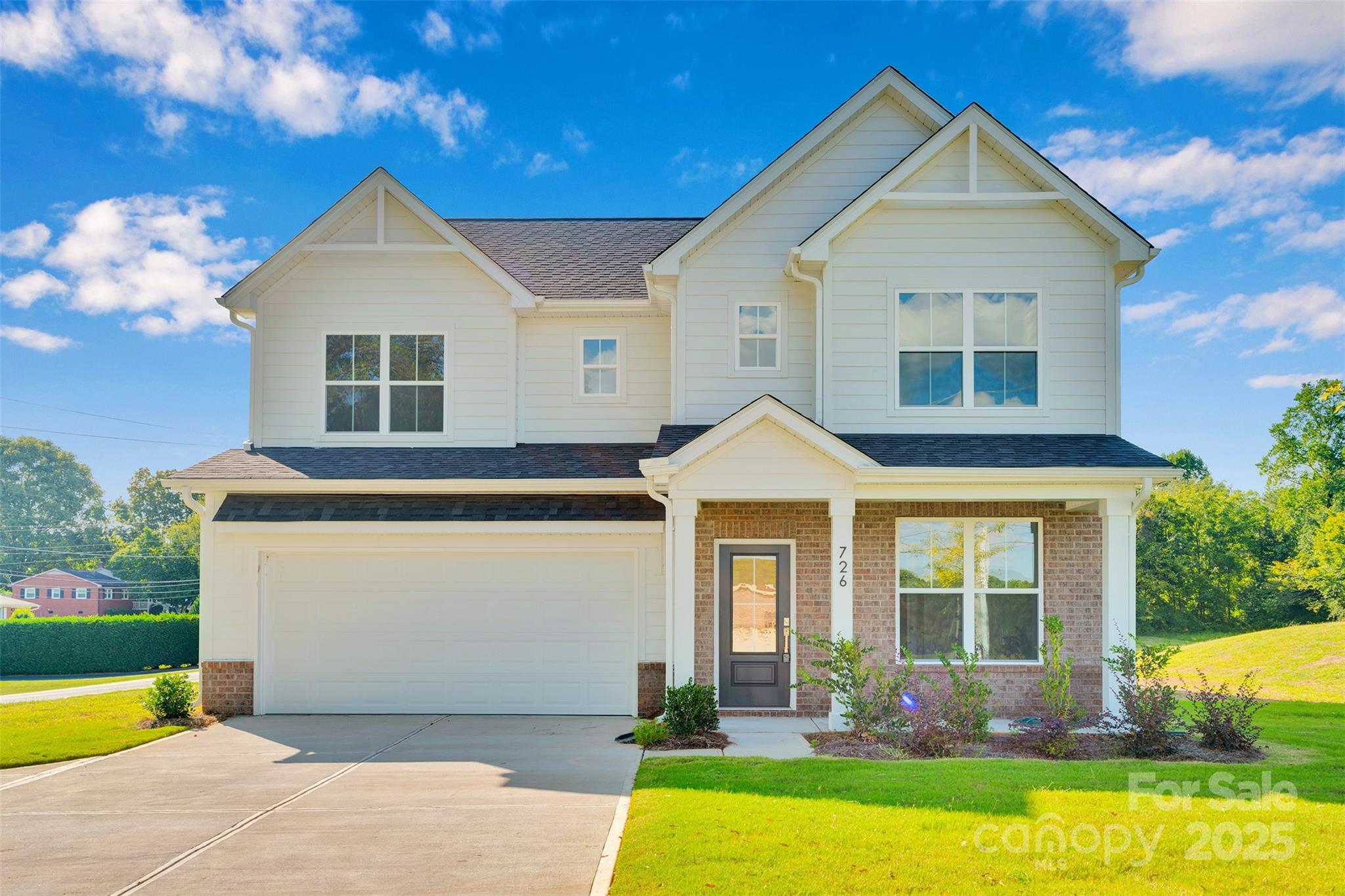 a front view of a house with garden