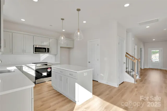 a kitchen with granite countertop a stove and a sink