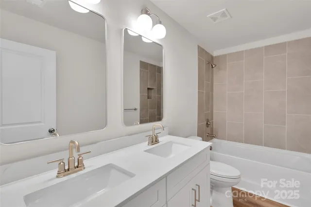 a bathroom with a tub a sink and a large mirror