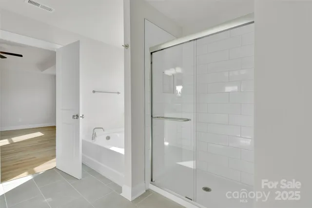 a bathroom with a bathtub and a shower