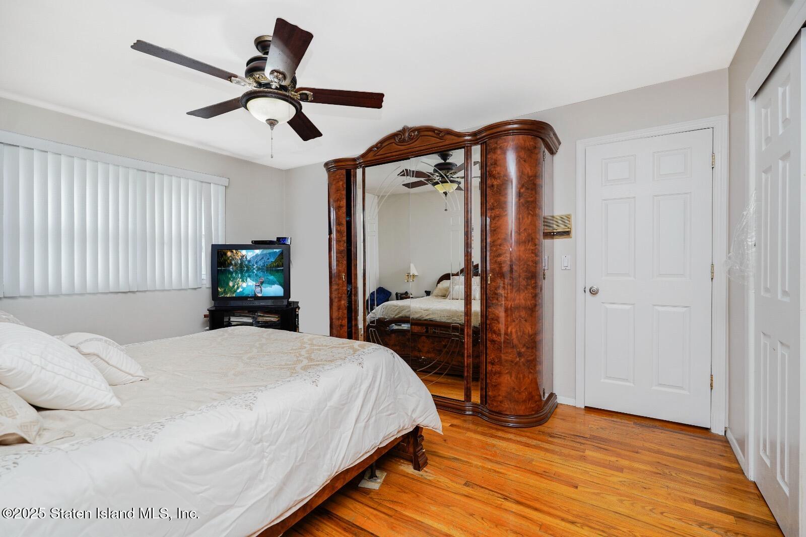 10 Draper Place Staten Island, NY 10314 - Photo 11 of 20 a bedroom with a bed and wooden floor