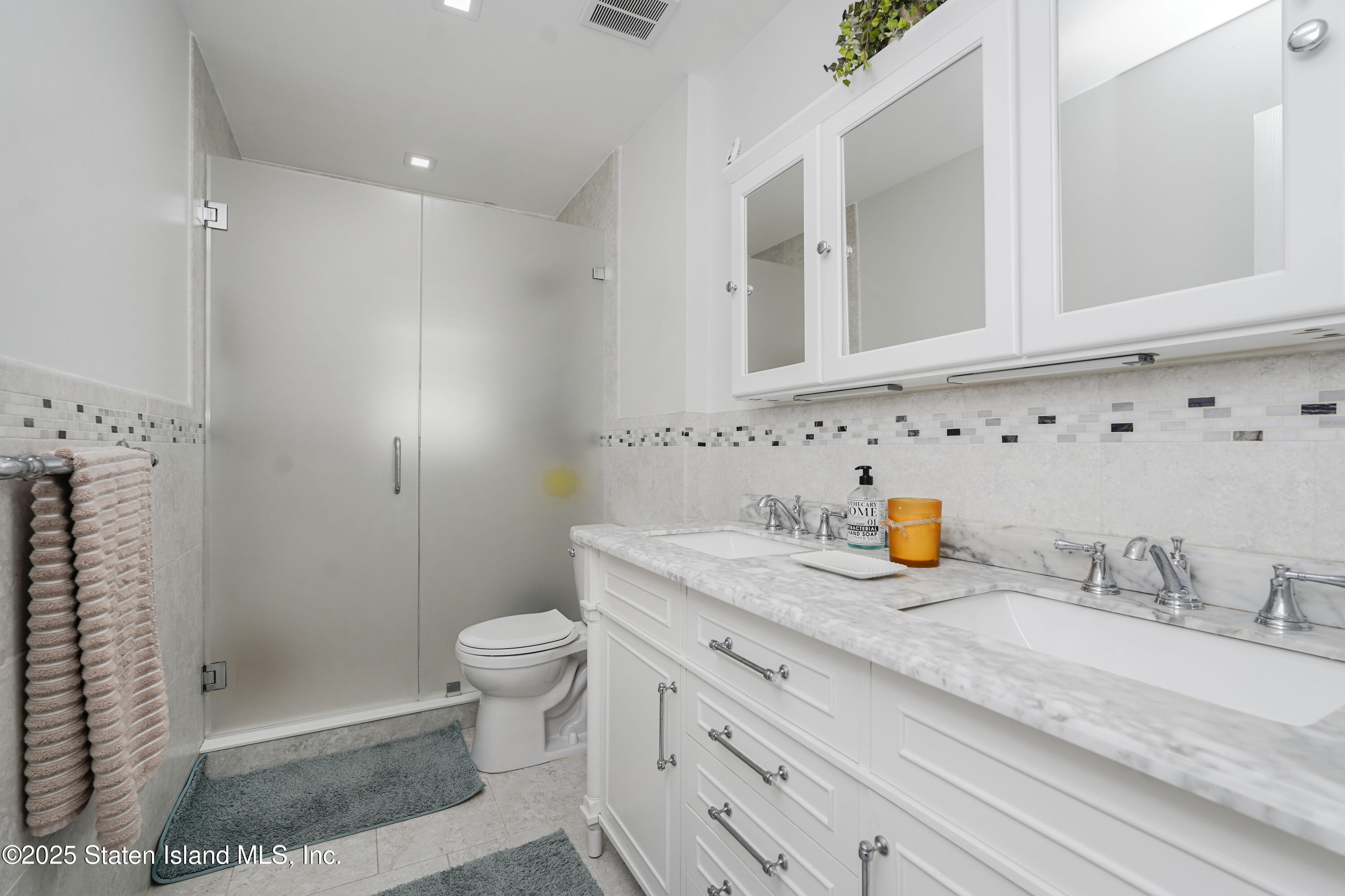 10 Draper Place Staten Island, NY 10314 - Photo 14 of 20 a bathroom with a sink a toilet and shower