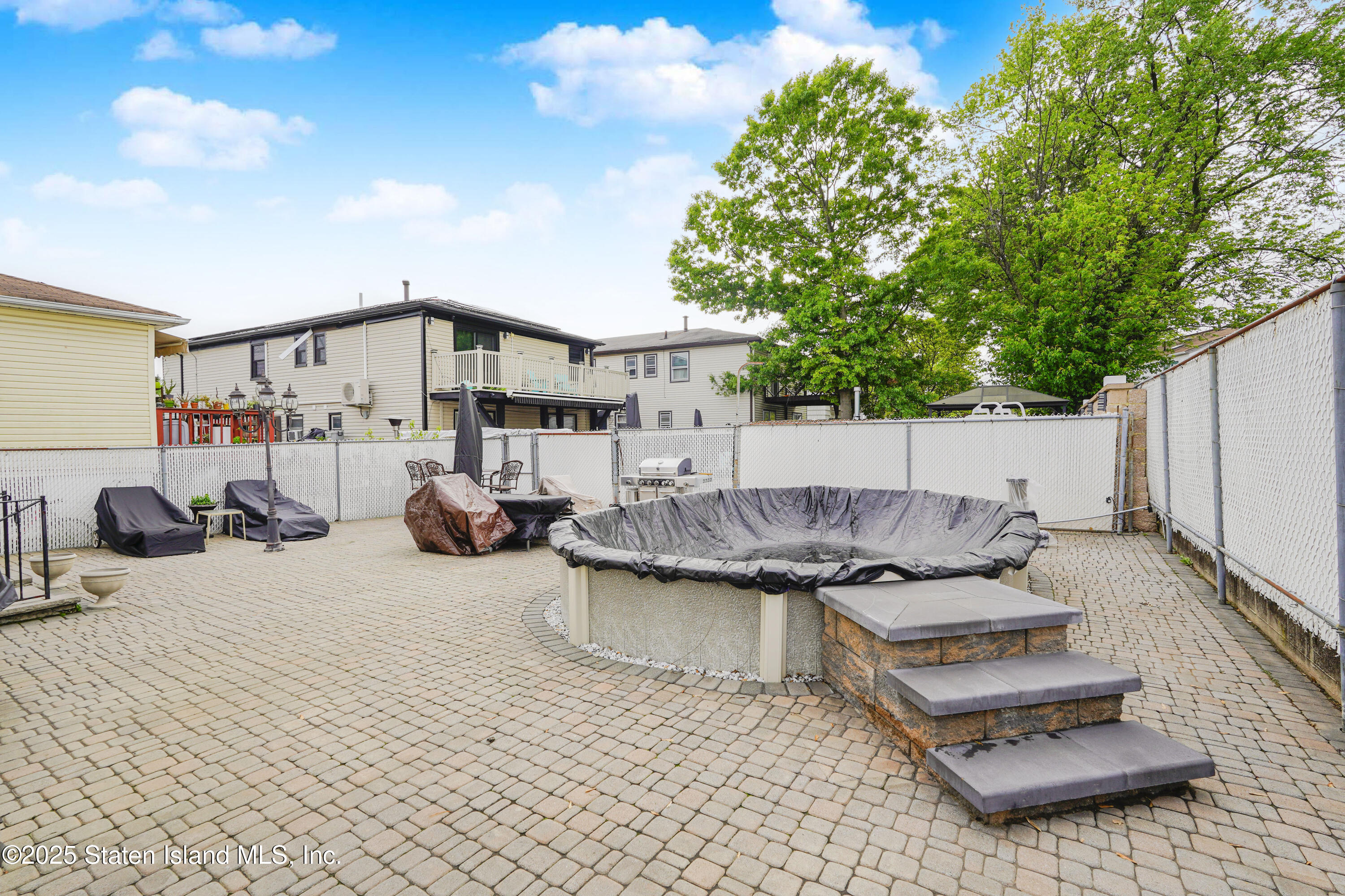 10 Draper Place Staten Island, NY 10314 - Photo 18 of 20 a view of a patio with furniture and a tree