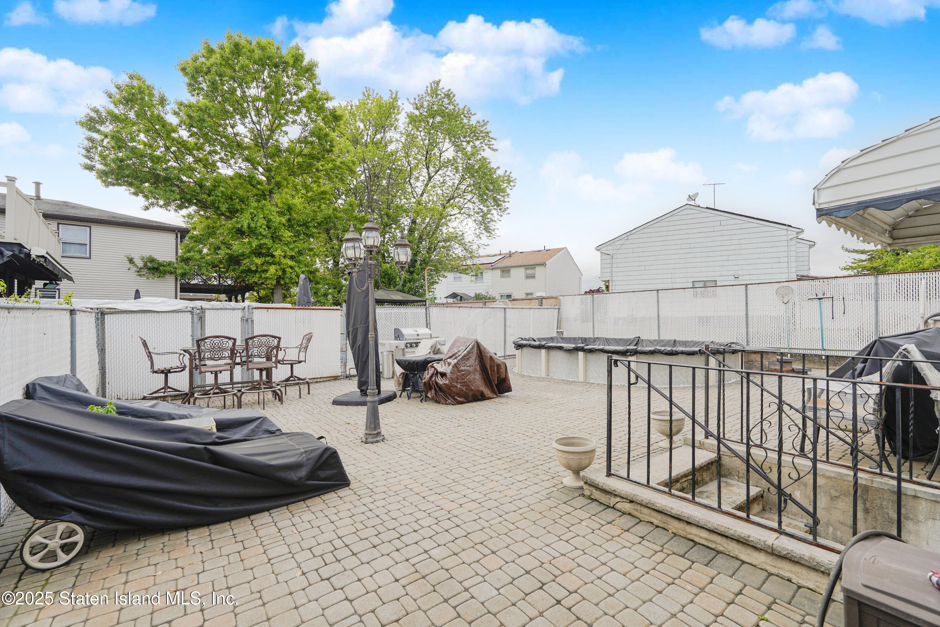 10 Draper Place Staten Island, NY 10314 - Photo 20 of 20 a view of a chairs and tables in the back yard of the house