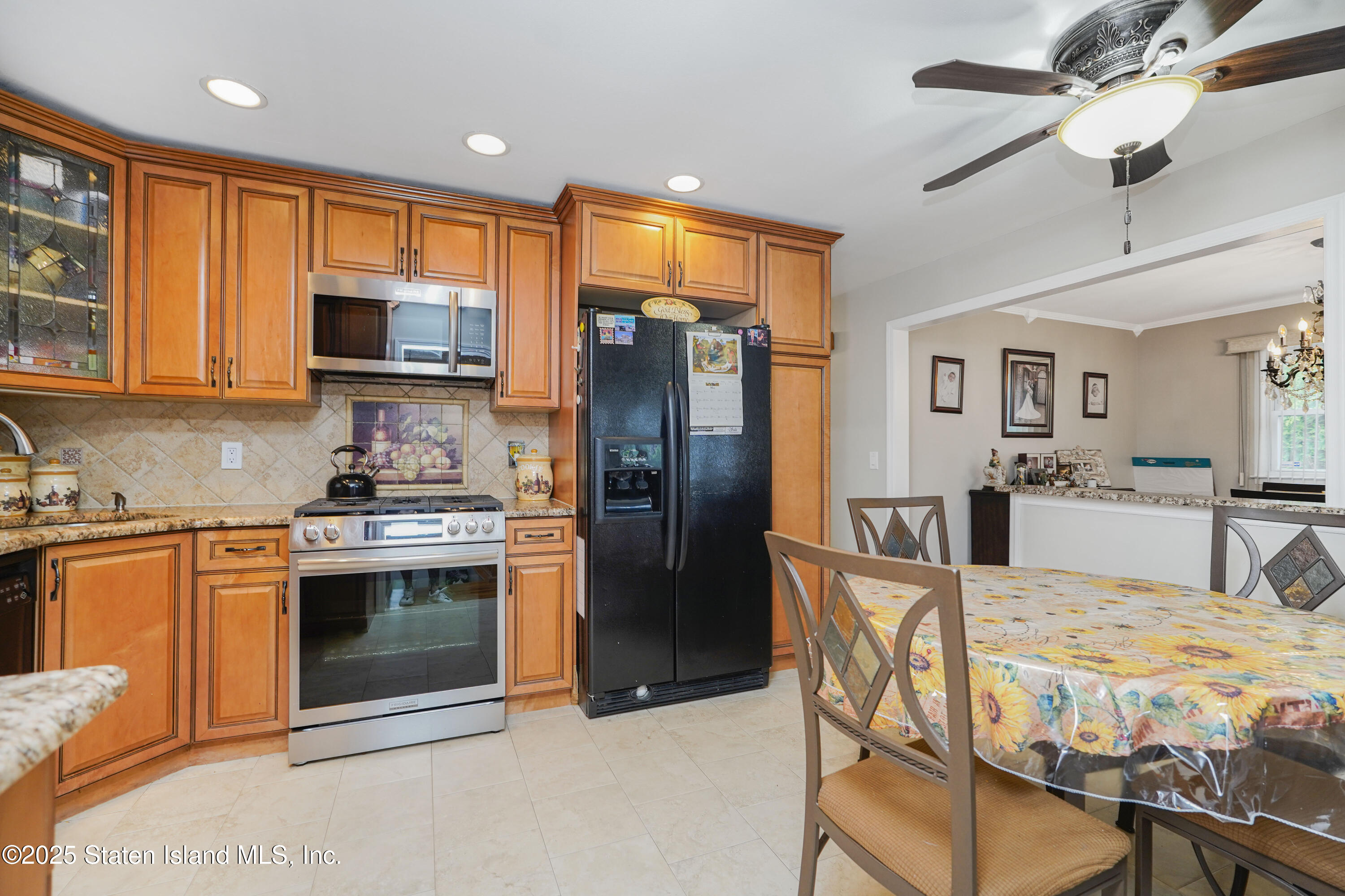 10 Draper Place Staten Island, NY 10314 - Photo 4 of 20 a kitchen with stainless steel appliances granite countertop a stove a sink and a refrigerator