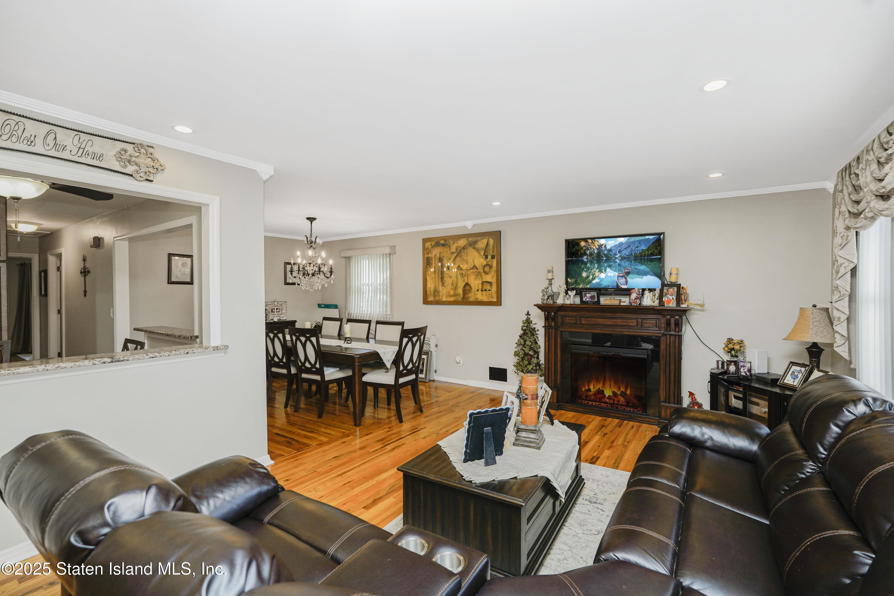 10 Draper Place Staten Island, NY 10314 - Photo 6 of 20 a living room with furniture a flat screen tv and a fireplace