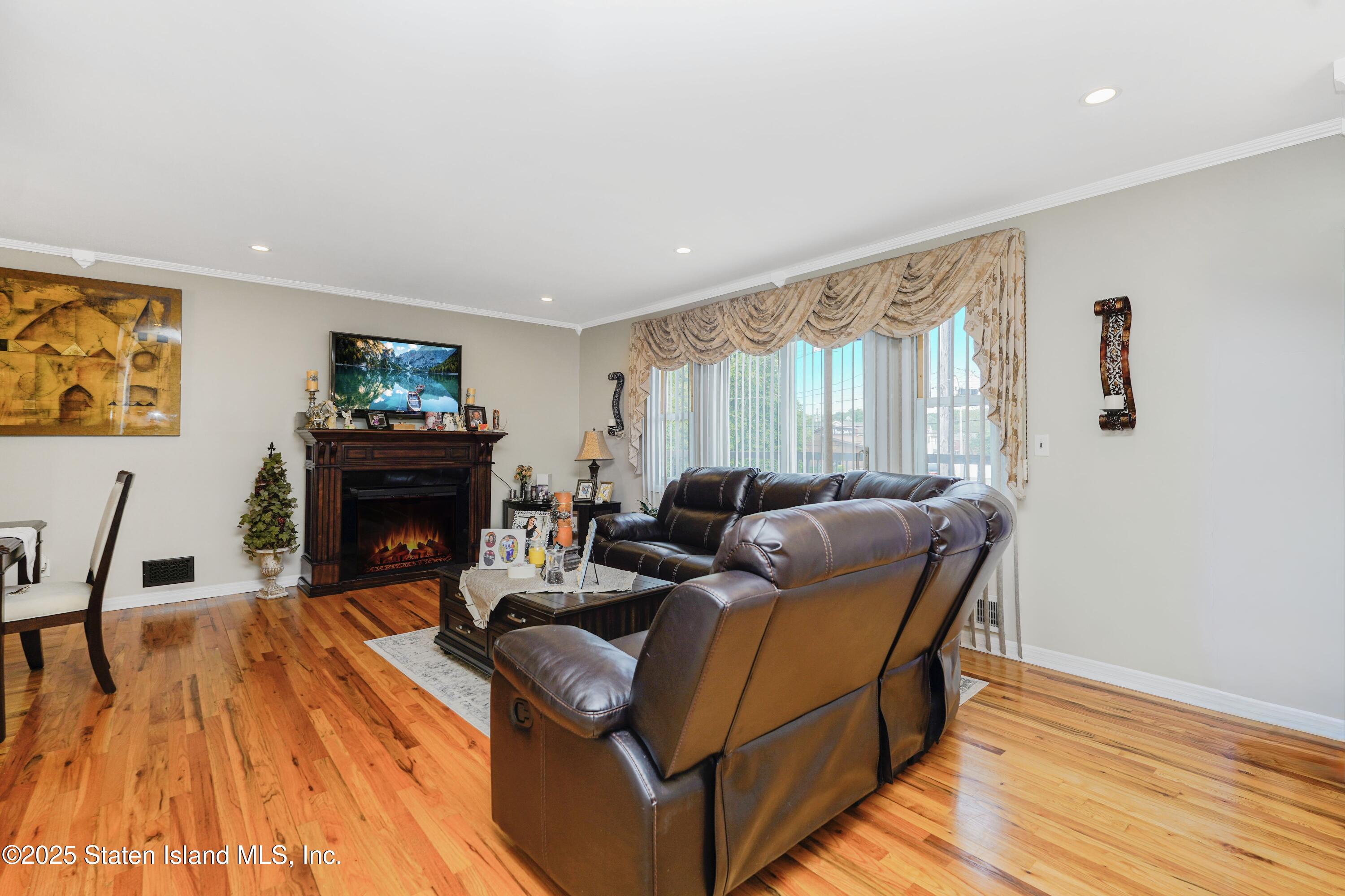 10 Draper Place Staten Island, NY 10314 - Photo 8 of 20 a living room with furniture and a fireplace