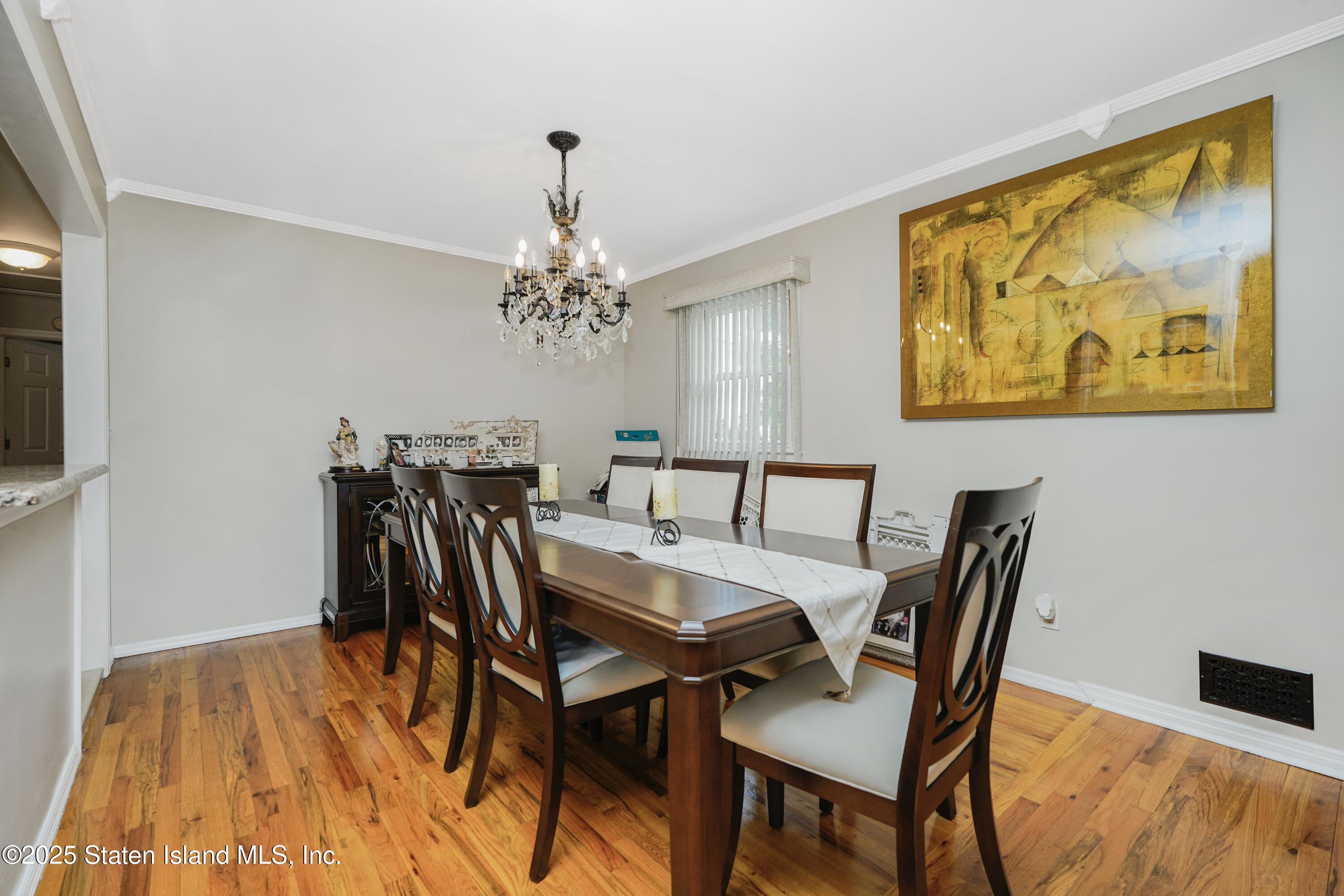10 Draper Place Staten Island, NY 10314 - Photo 9 of 20 a view of a dining room with furniture and chandelier