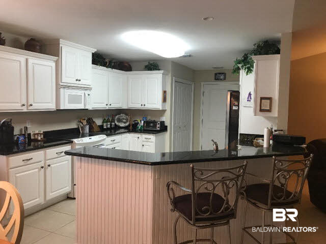 22765 Tranquil Lane Foley, AL 36535 - Photo 7 of 29 White Cabinets with Black granite