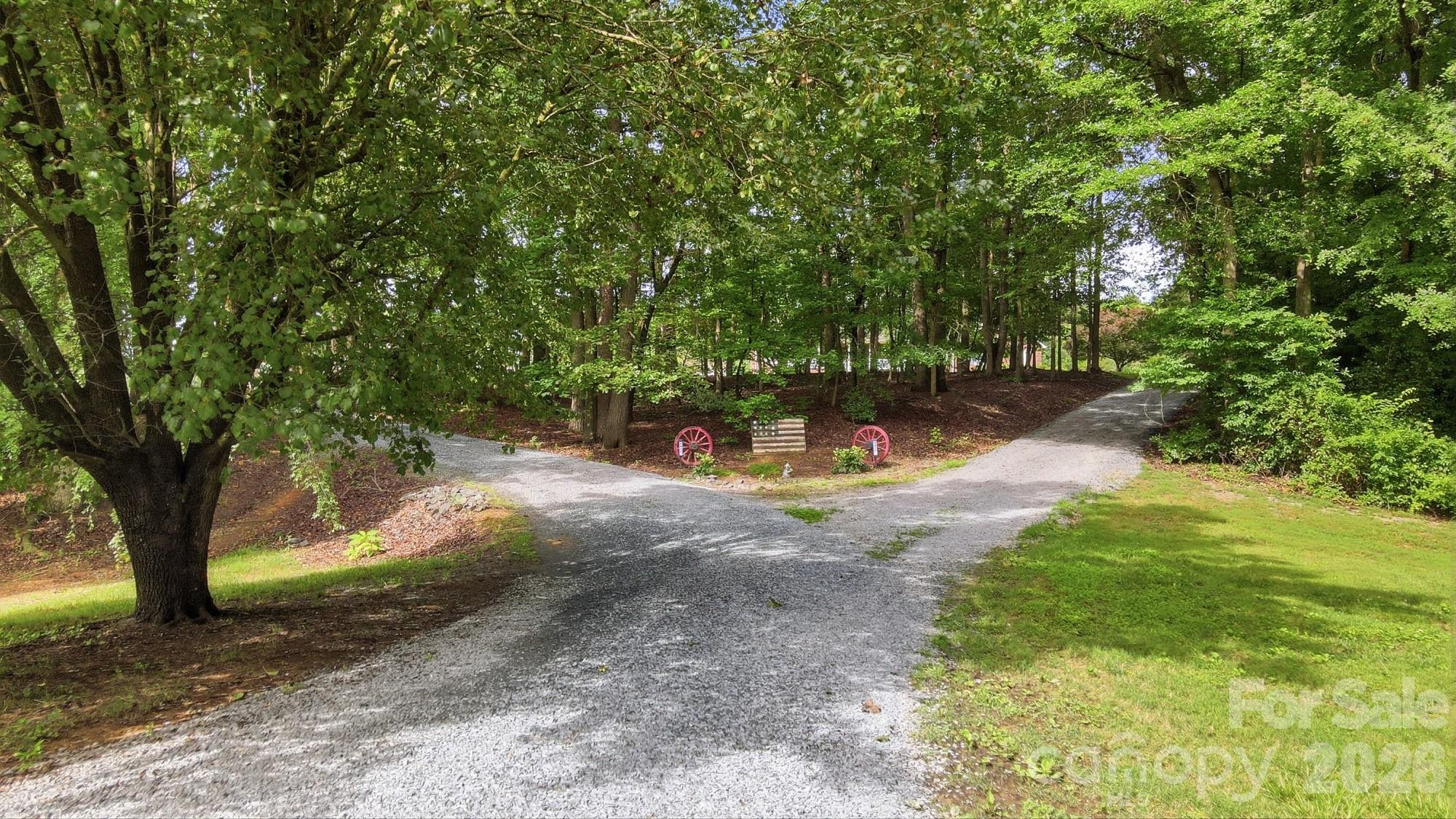 4017 Mullis Newsome Road Monroe, NC 28110 - Photo 6 of 38 a view of a tree in the middle of a yard