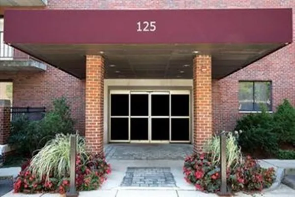 front view of a house with a tree