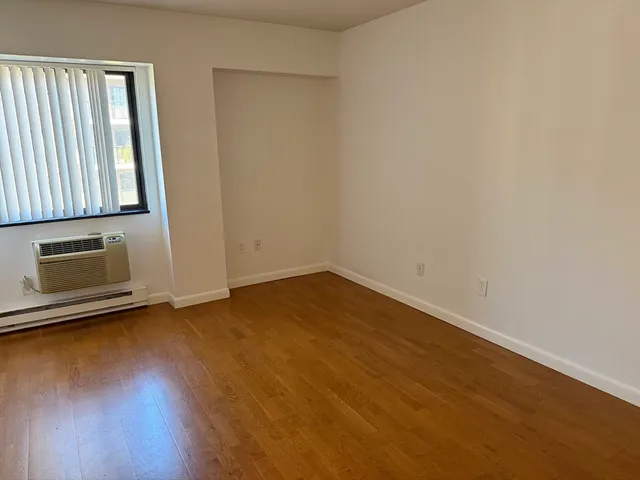 a view of a room with wooden floor