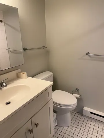 a bathroom with a sink a toilet and mirror