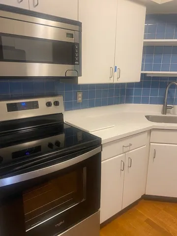 a utility room with cabinets washer and dryer