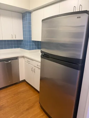 a kitchen with a sink a stove and cabinets