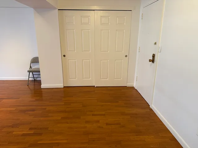 a view of a kitchen with wooden floor and a sink