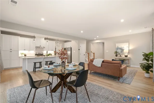 a view of a dining room with furniture and wooden floor