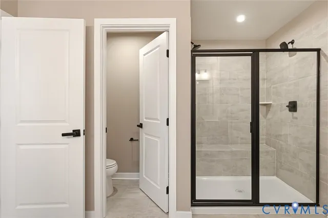 a bathroom with a shower and a glass door