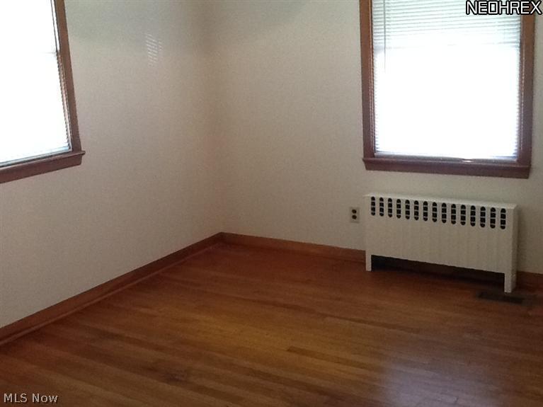 9850 West Pleasant Valley Road Parma, OH 44130 - Photo 5 of 15 Bedroom One on the first floor has shining hardwood flooring.