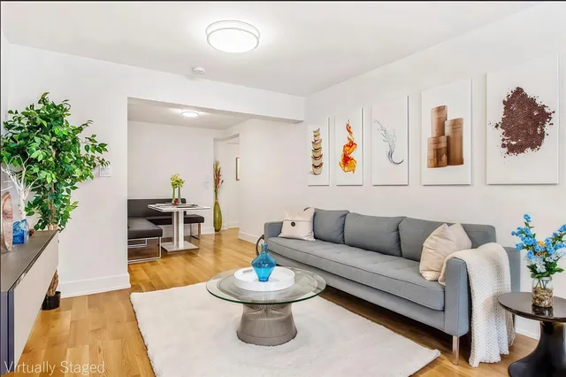 a living room with furniture and flowers