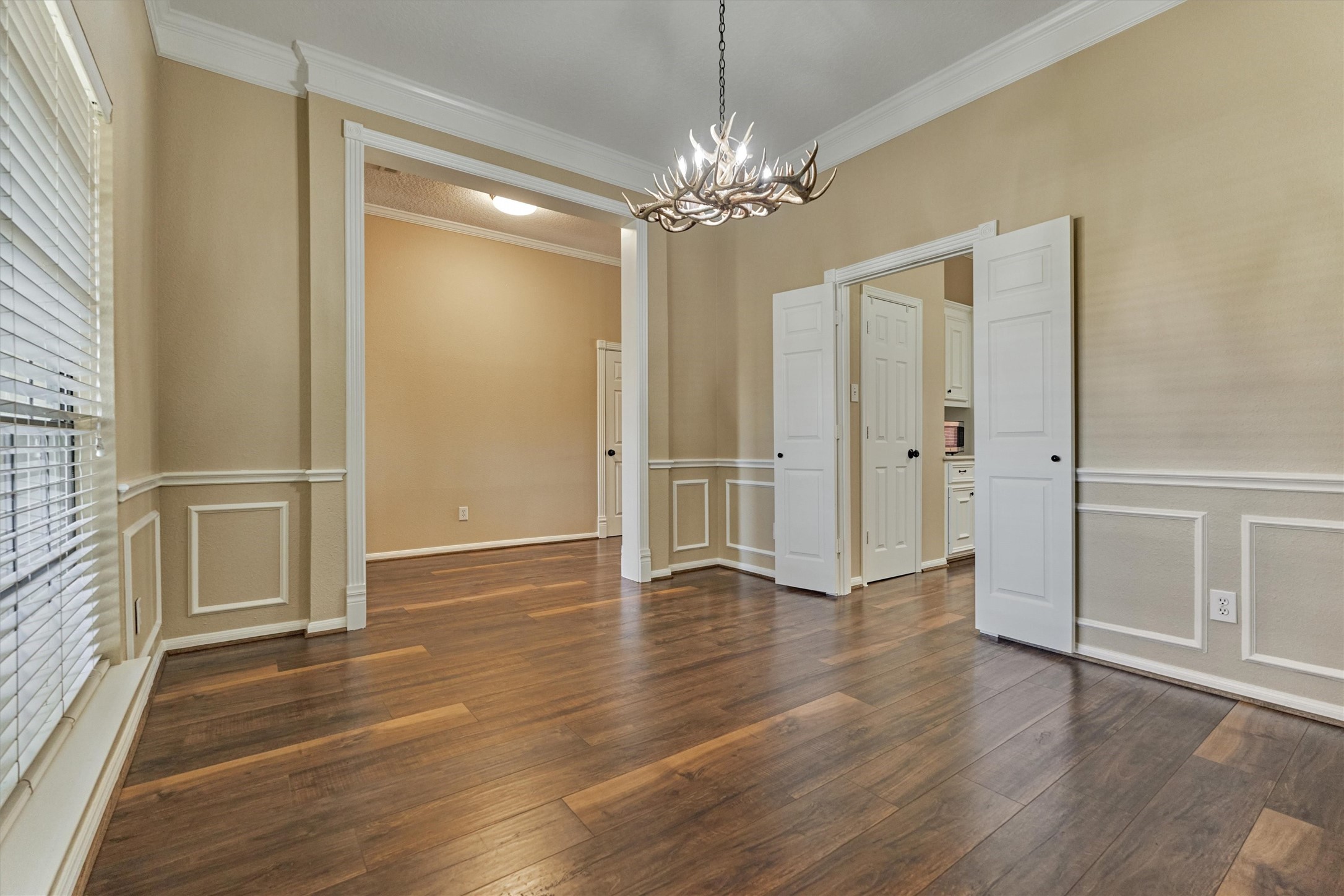 16024 Rabon Chapel Road Montgomery, TX 77316 - Photo 14 of 43 Another view of the dining room shows double doors leading to the kitchen. The trim and moldings in this room give it an extra level of custom detail and elegance.