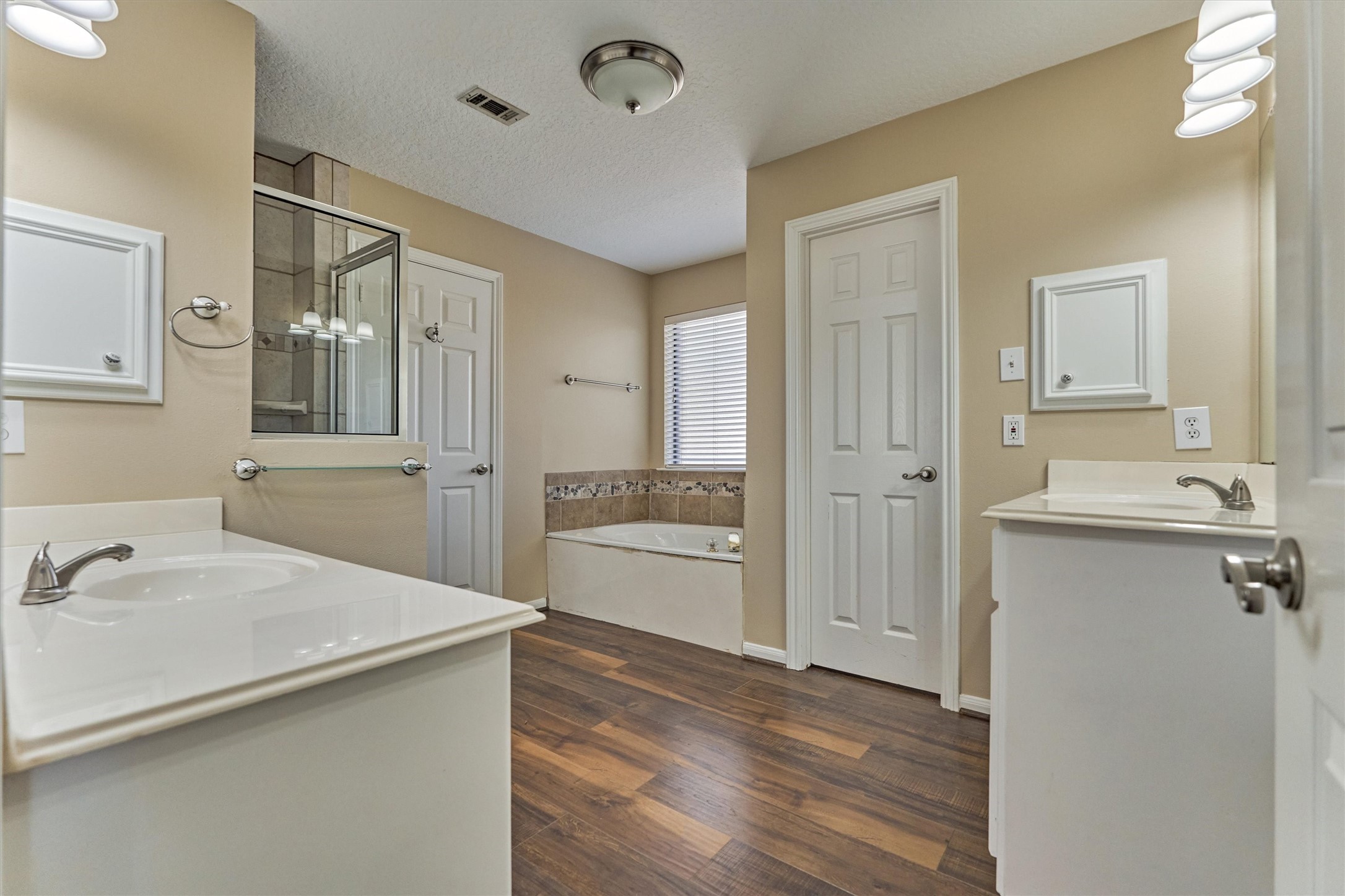 16024 Rabon Chapel Road Montgomery, TX 77316 - Photo 25 of 43 The primary ensuite bath features double sinks, a jetted soaking tub, shower and walk-in closet. An additional closet is located in the primary bedroom.
