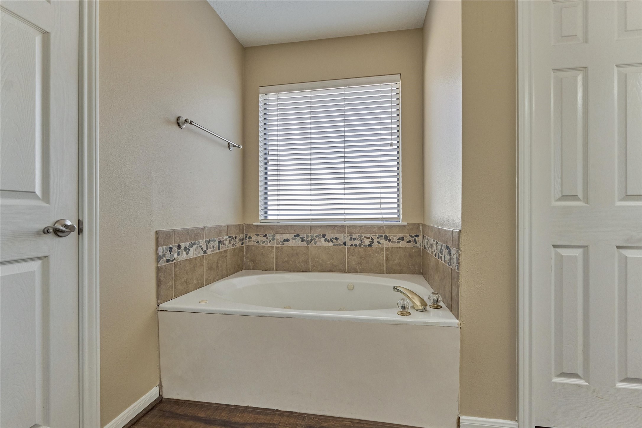 16024 Rabon Chapel Road Montgomery, TX 77316 - Photo 27 of 43 Jetted soaking tub has tile surround and a window to allow natural light; great for soaking at the end of a long day.
