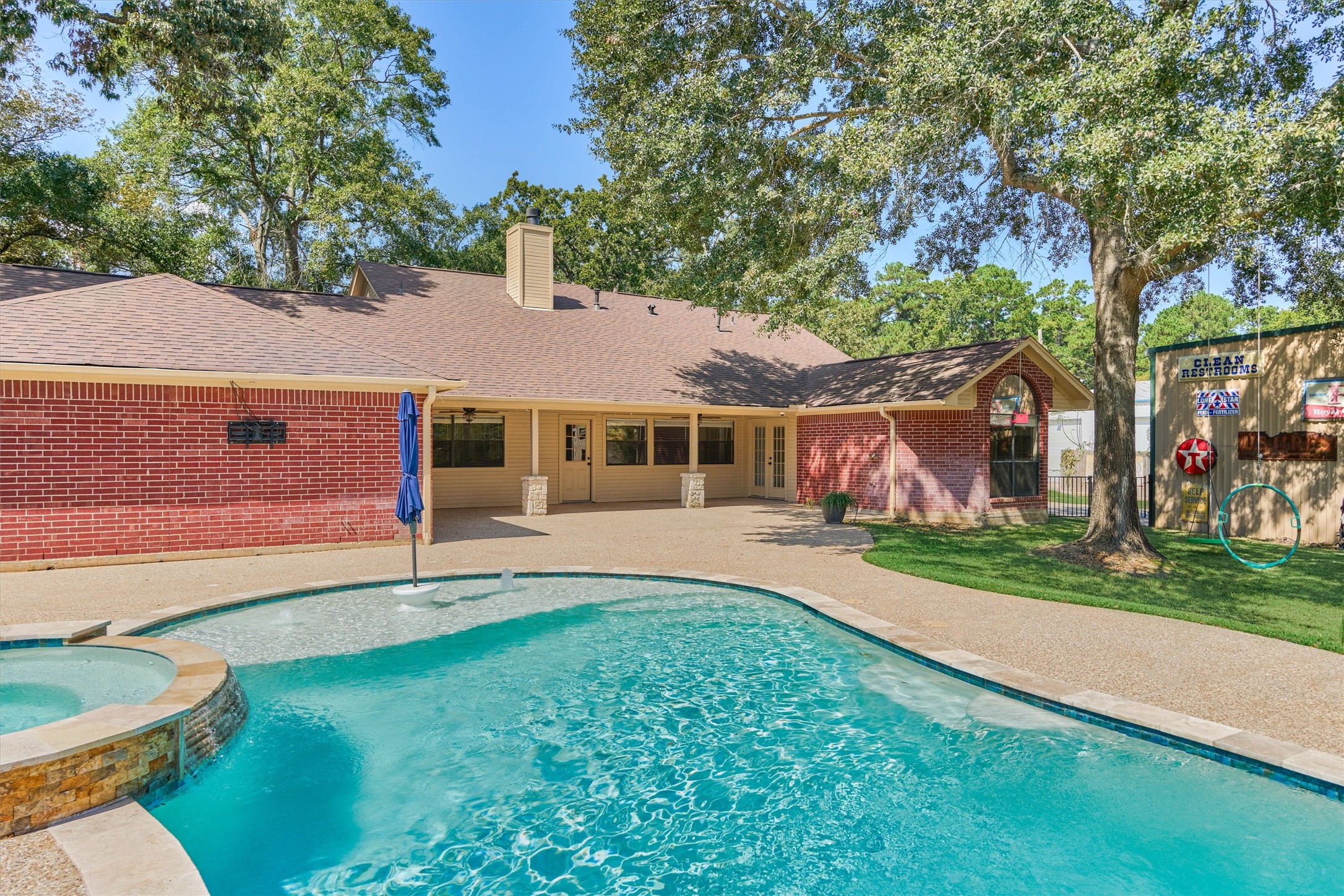 16024 Rabon Chapel Road Montgomery, TX 77316 - Photo 42 of 43 A covered back porch with access to the garage and home creates a great, relaxing spot for enjoying the backyard.
