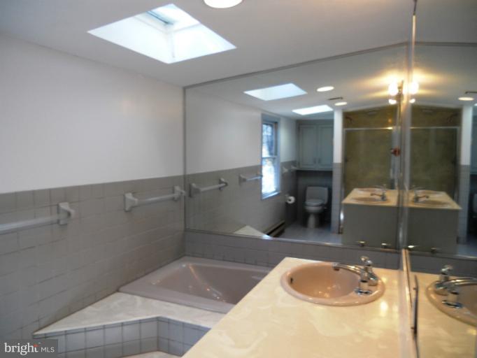805 Tred Avon Road Baltimore, MD 21212 - Photo 14 of 19 a bathroom with a sink and shower