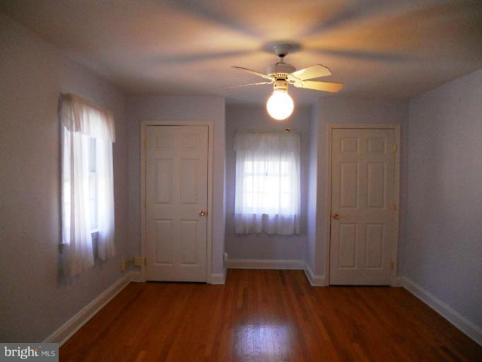 805 Tred Avon Road Baltimore, MD 21212 - Photo 4 of 19 a view of an empty room with wooden floor and a window