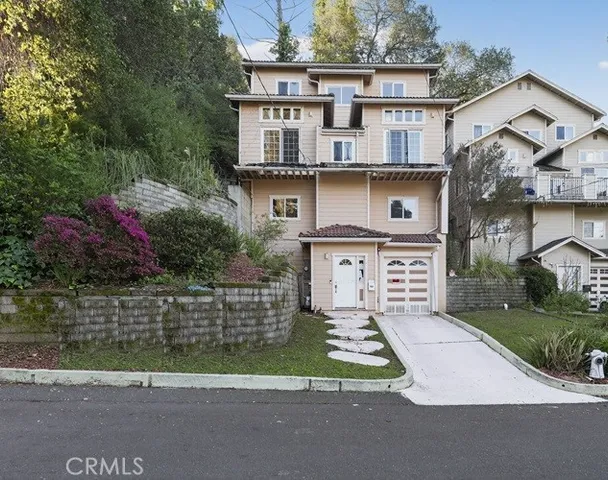 a front view of a house with a garden