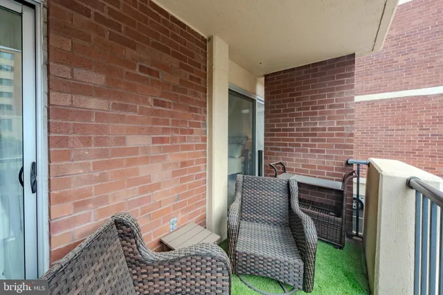 a brick house with chairs in front of it
