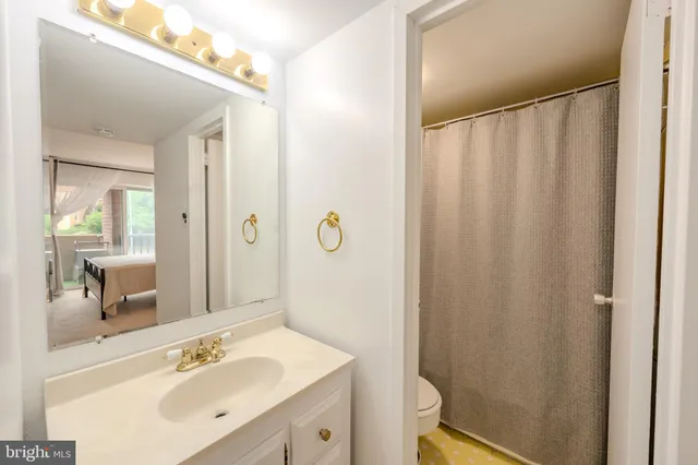 a bathroom with a sink a mirror and a shower