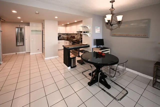 a kitchen with stainless steel appliances kitchen island granite countertop a sink and a refrigerator