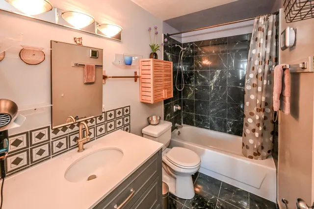 a bathroom with a sink toilet and shower