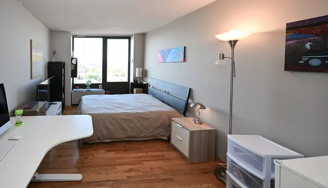 a bedroom with a bed and a tv